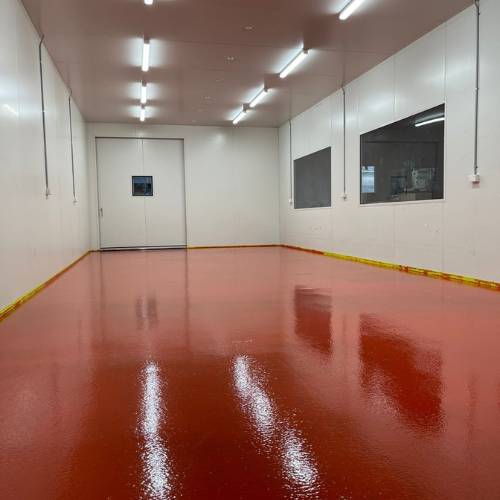 Photo shows the Brite Food Room which has bright red flooring and white walls.