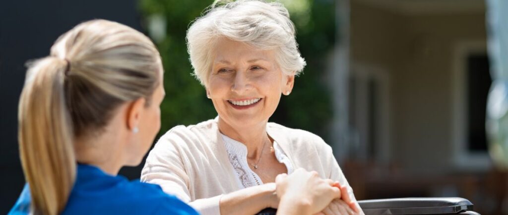 An elderly woman smiling at student undertaking a Certificate III Individual Support (CH33021).